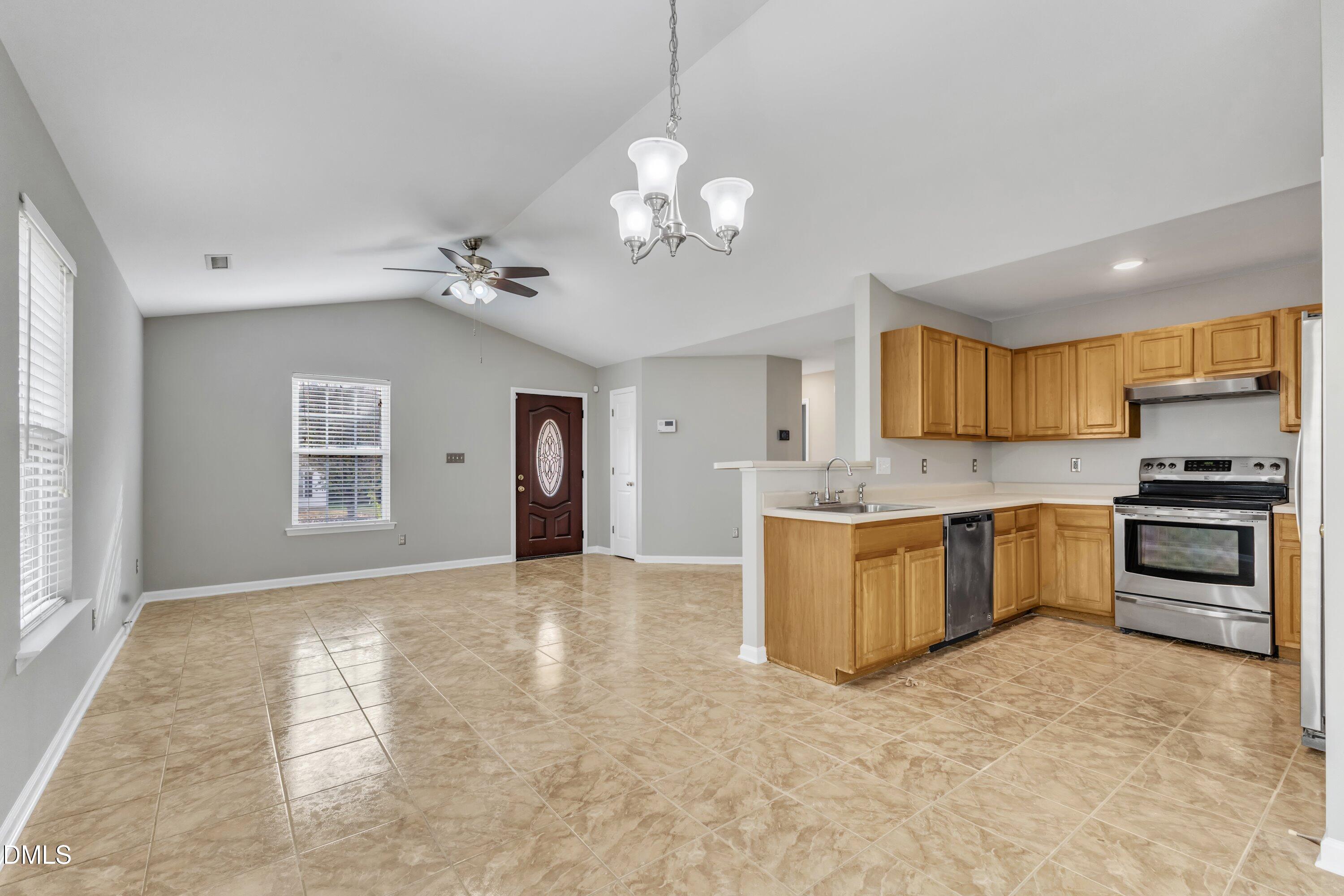4917 Silverdene Street Raleigh, NC 27616 - Photo 14 of 35 a view of a kitchen with a sink and a stove top oven