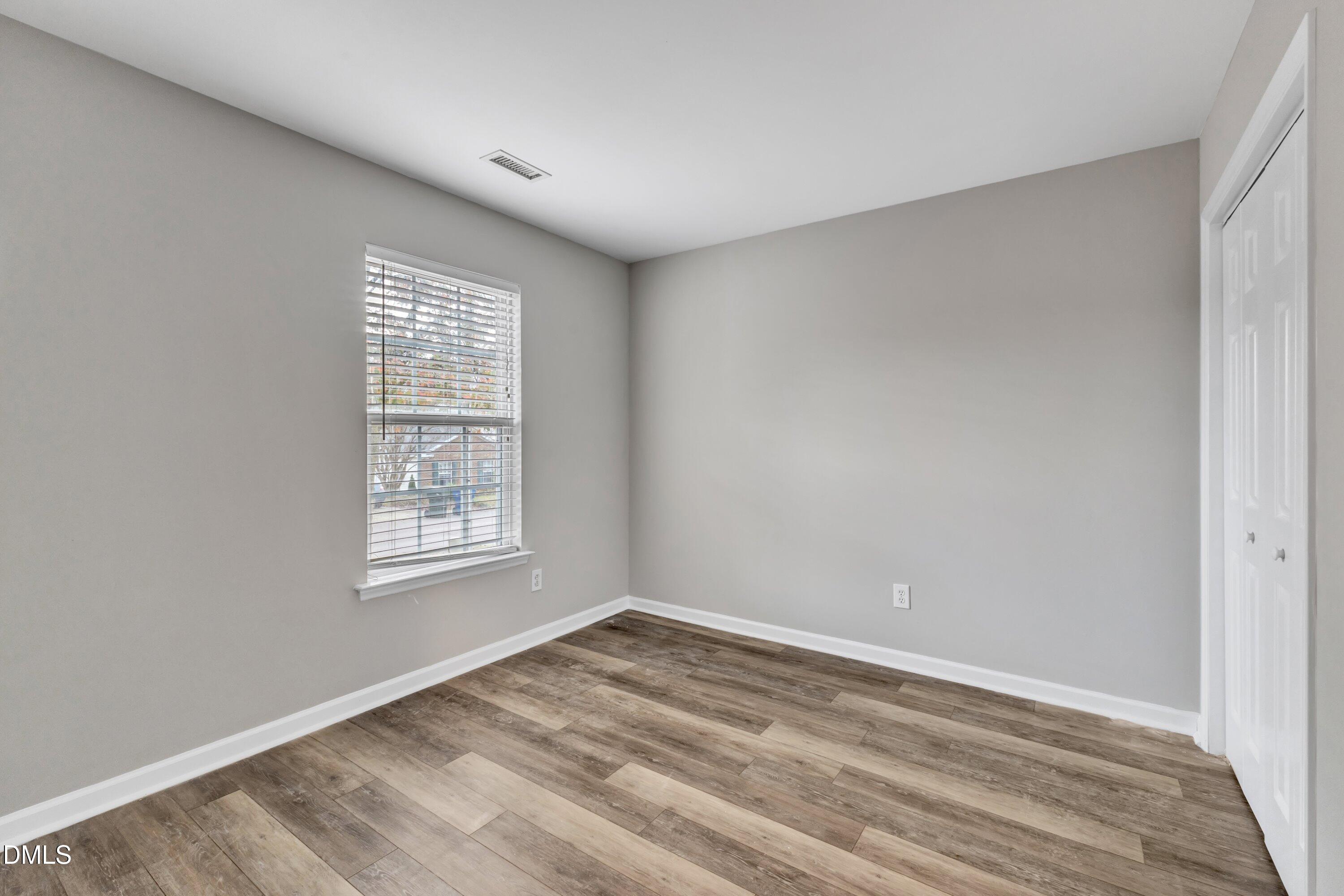 4917 Silverdene Street Raleigh, NC 27616 - Photo 22 of 35 wooden floor in an empty room with a window
