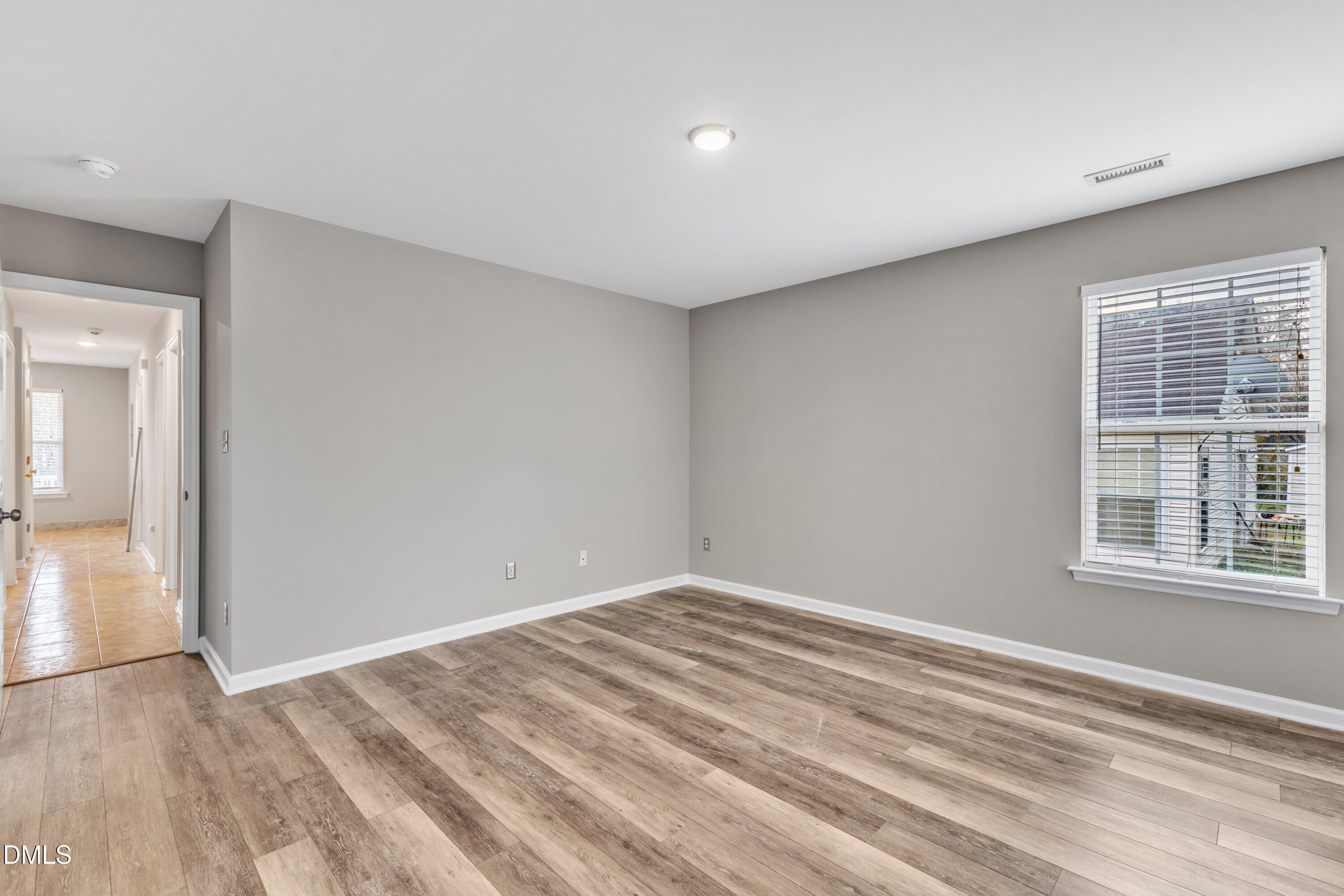 4917 Silverdene Street Raleigh, NC 27616 - Photo 30 of 35 a view of empty room with wooden floor and fan