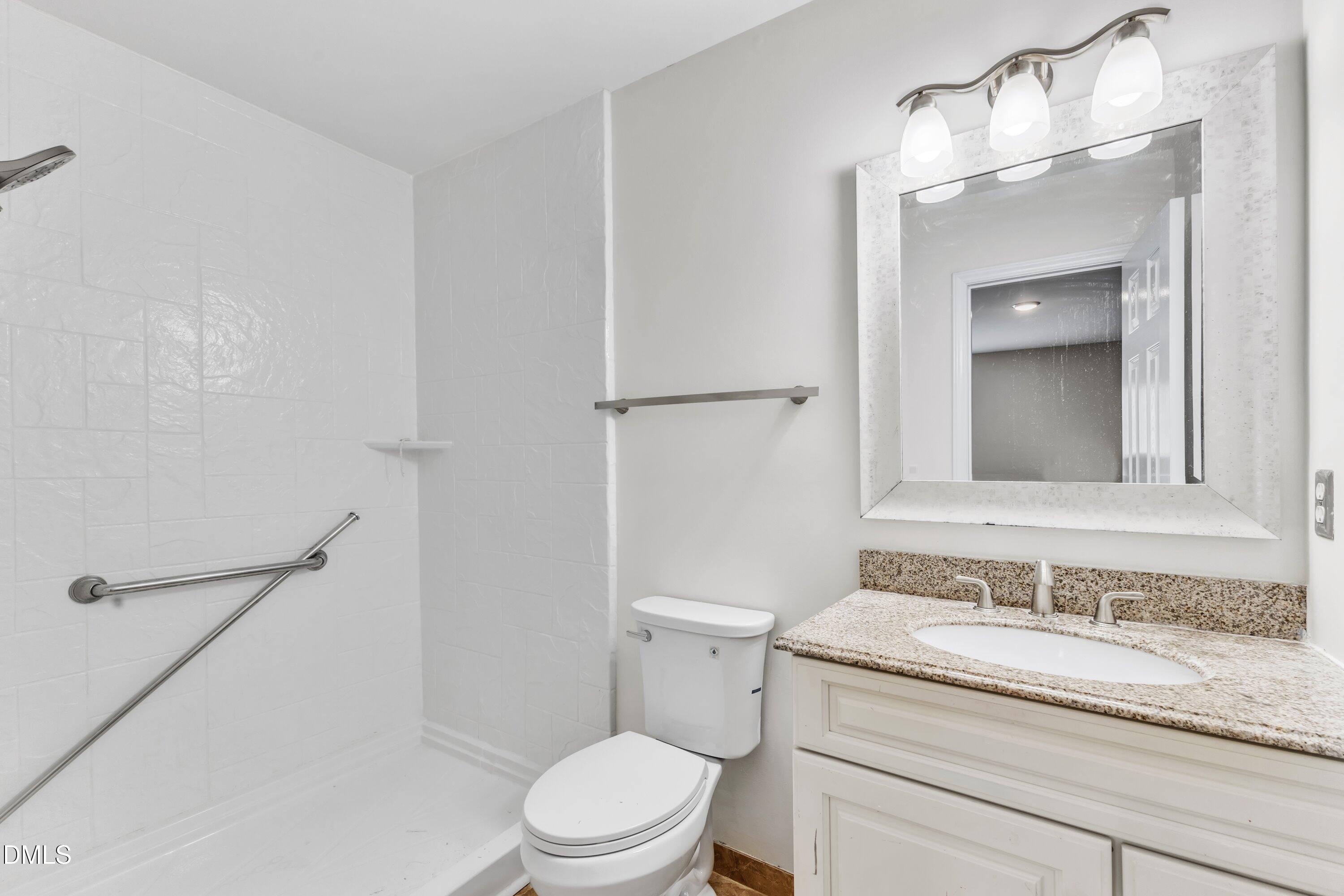 4917 Silverdene Street Raleigh, NC 27616 - Photo 31 of 35 a bathroom with a granite countertop sink toilet and shower