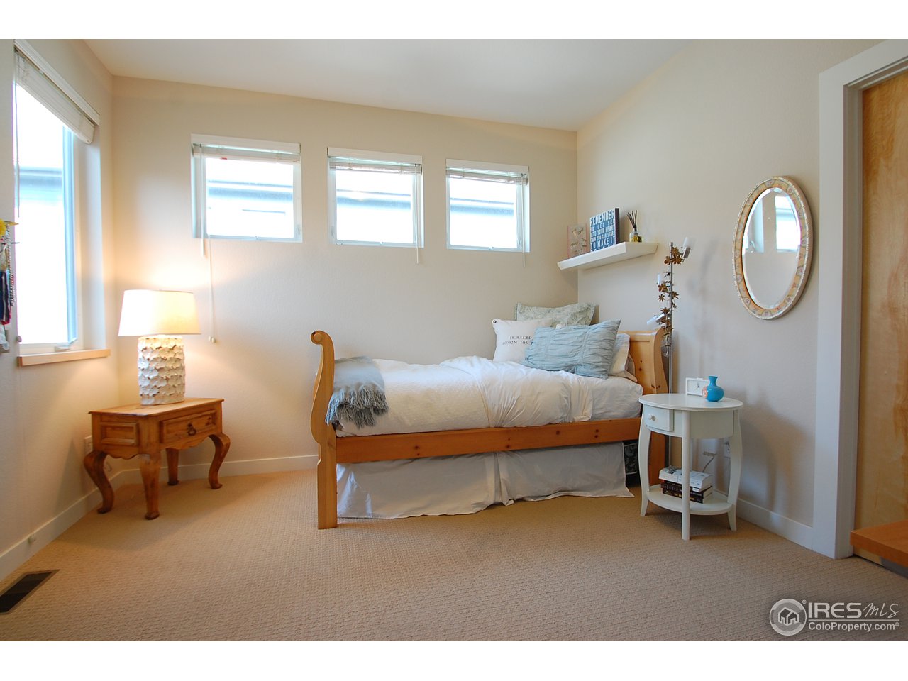 5247 5th Street Boulder, CO 80304 - Photo 17 of 22 a bedroom with a bed a chandelier and dresser