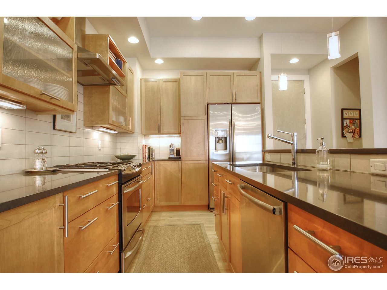 5247 5th Street Boulder, CO 80304 - Photo 9 of 22 a kitchen with stainless steel appliances granite countertop a sink a stove and a refrigerator