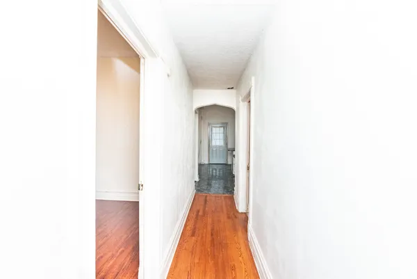 a view of a hallway with a white walls