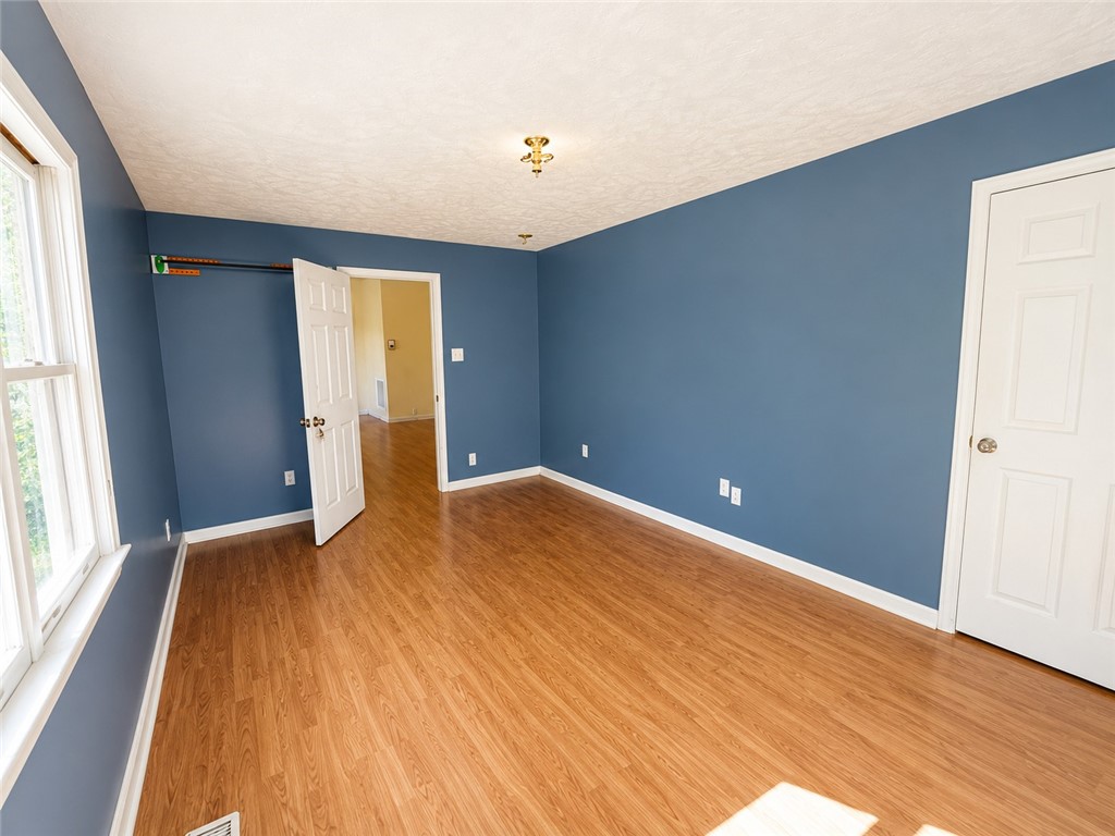 597 Old Hurricane Road Westminster, SC 29693 - Photo 8 of 11 Well-lit room with wood flooring provides a versatile living space.