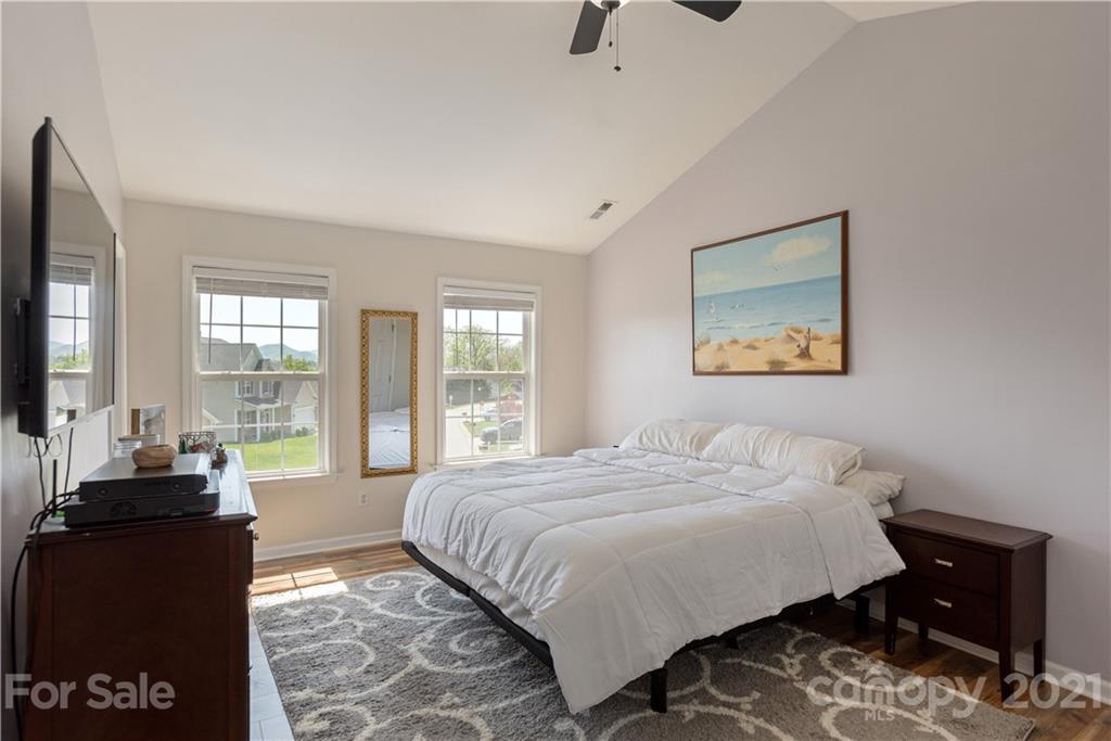 312 Black River Road Fletcher, NC 28732 - Photo 16 of 29 a bedroom with a bed and wooden floor