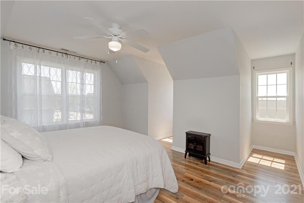 312 Black River Road Fletcher, NC 28732 - Photo 25 of 29 a spacious bedroom with a bed and a large window