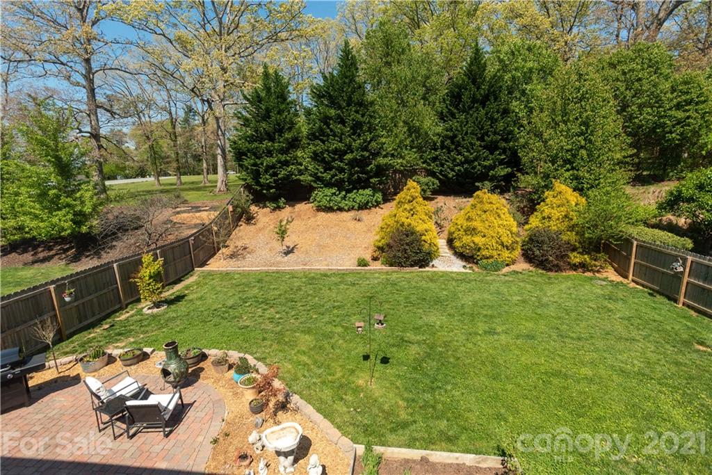 312 Black River Road Fletcher, NC 28732 - Photo 26 of 29 a view of a backyard with table and chairs potted plants and large tree