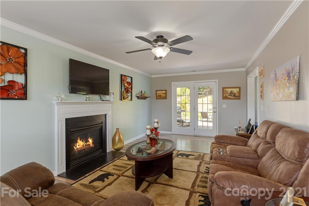 312 Black River Road Fletcher, NC 28732 - Photo 5 of 29 a living room with furniture a flat screen tv and a fireplace