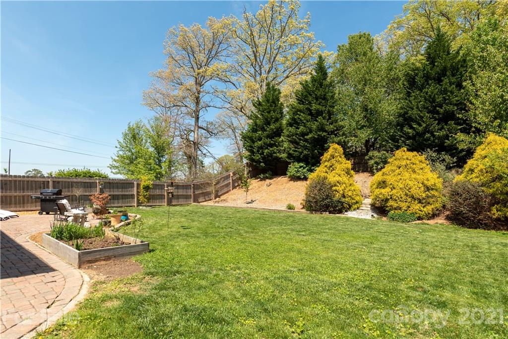312 Black River Road Fletcher, NC 28732 - Photo 9 of 29 a view of a swimming pool with some plants and large trees