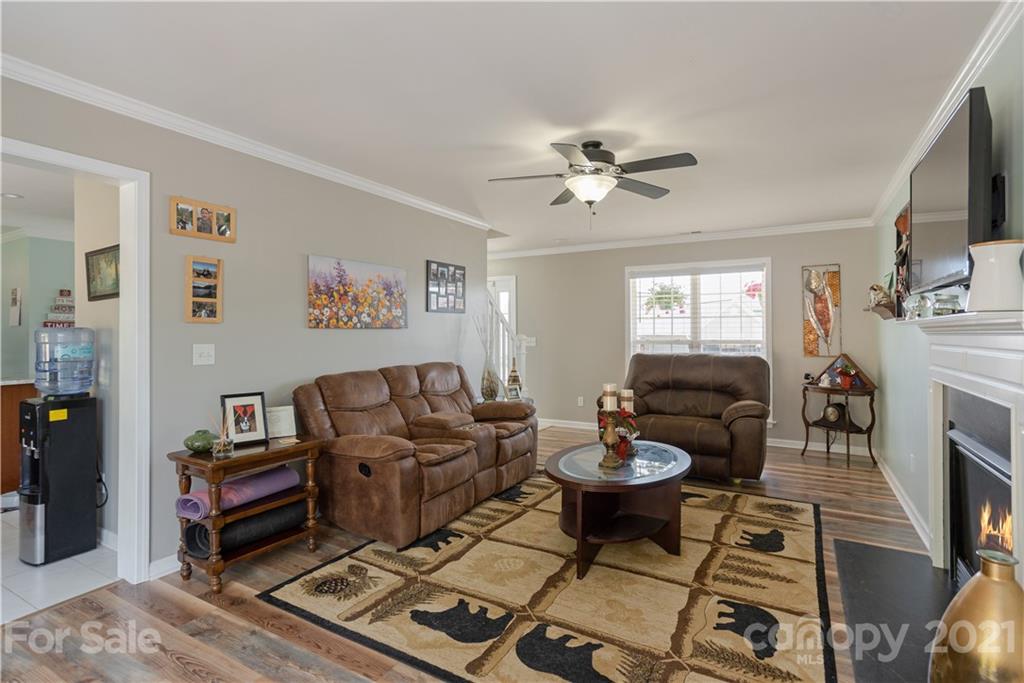 312 Black River Road Fletcher, NC 28732 - Photo 10 of 29 a living room with furniture a fireplace and a flat screen tv