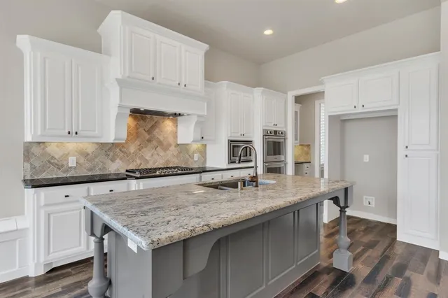 a kitchen with granite countertop a counter space and cabinets