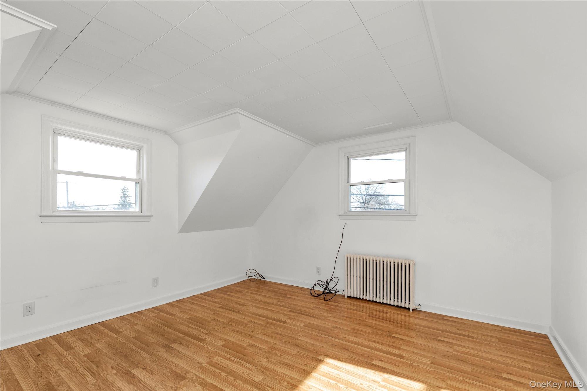 5 White Street Valley Stream, NY 11580 - Photo 14 of 23 an empty room with wooden floor and windows