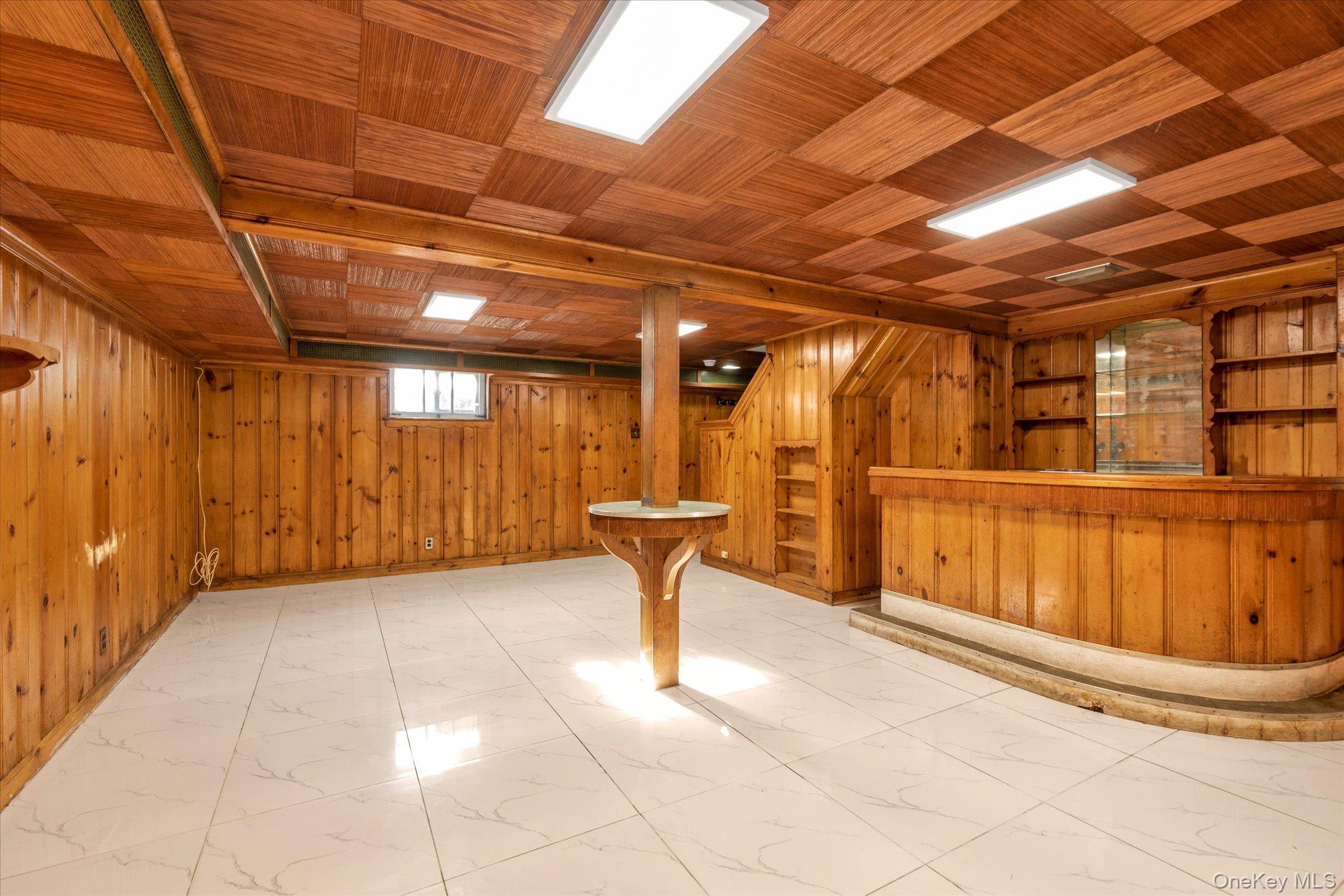 5 White Street Valley Stream, NY 11580 - Photo 17 of 23 a view of a garage with wooden table and chairs