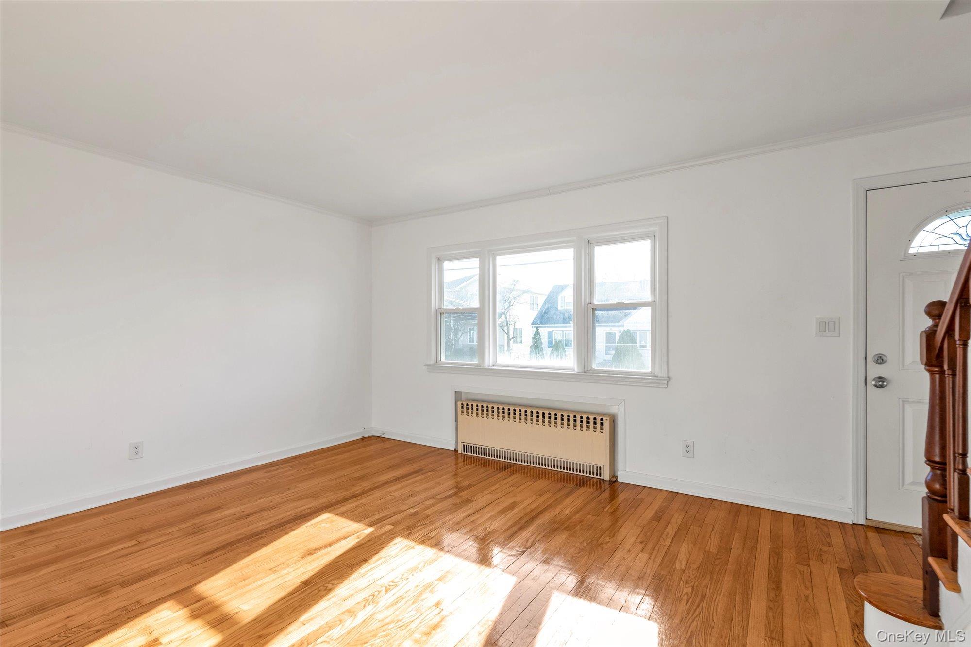 5 White Street Valley Stream, NY 11580 - Photo 3 of 23 a view of empty room with wooden floor and fan