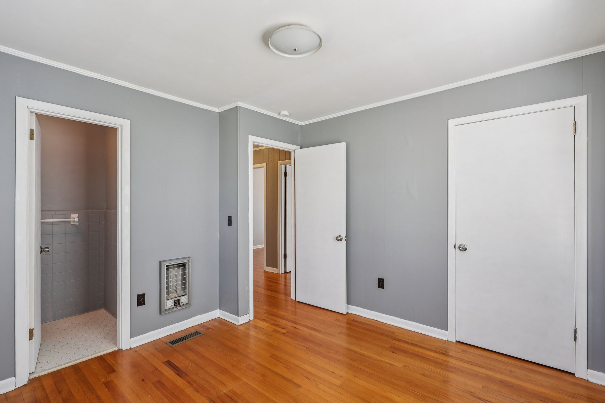 404 8th Avenue North Decherd, TN 37324 - Photo 11 of 23 a view of an empty room with wooden floor and a bathroom