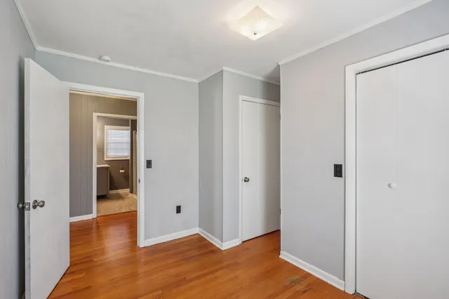 a view of a hallway with wooden floor