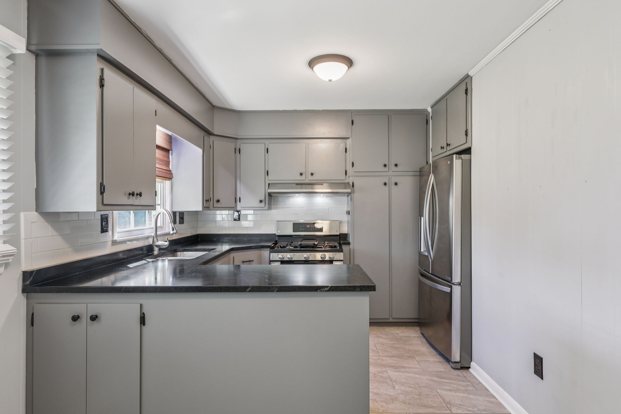 404 8th Avenue North Decherd, TN 37324 - Photo 6 of 23 a kitchen with stainless steel appliances granite countertop a refrigerator a sink and white cabinets