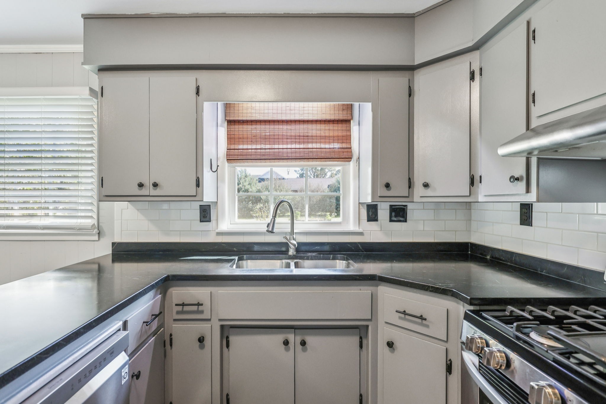 404 8th Avenue North Decherd, TN 37324 - Photo 7 of 23 a kitchen with granite countertop a sink a stove and cabinets