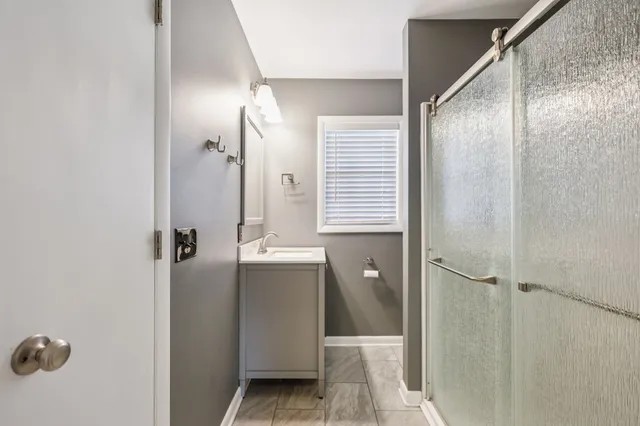 a bathroom with a shower and a sink