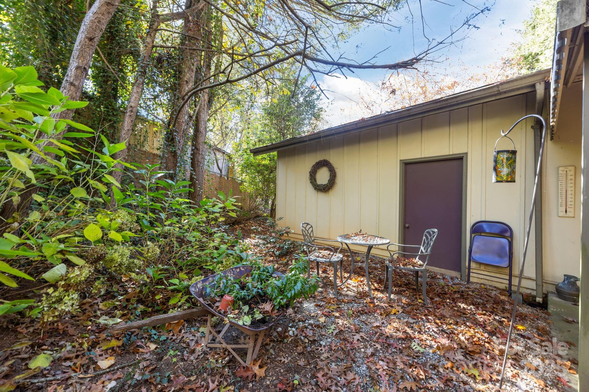 3228 Sweeten Creek Road Asheville, NC 28803 - Photo 11 of 48 a backyard of a house with table and chairs