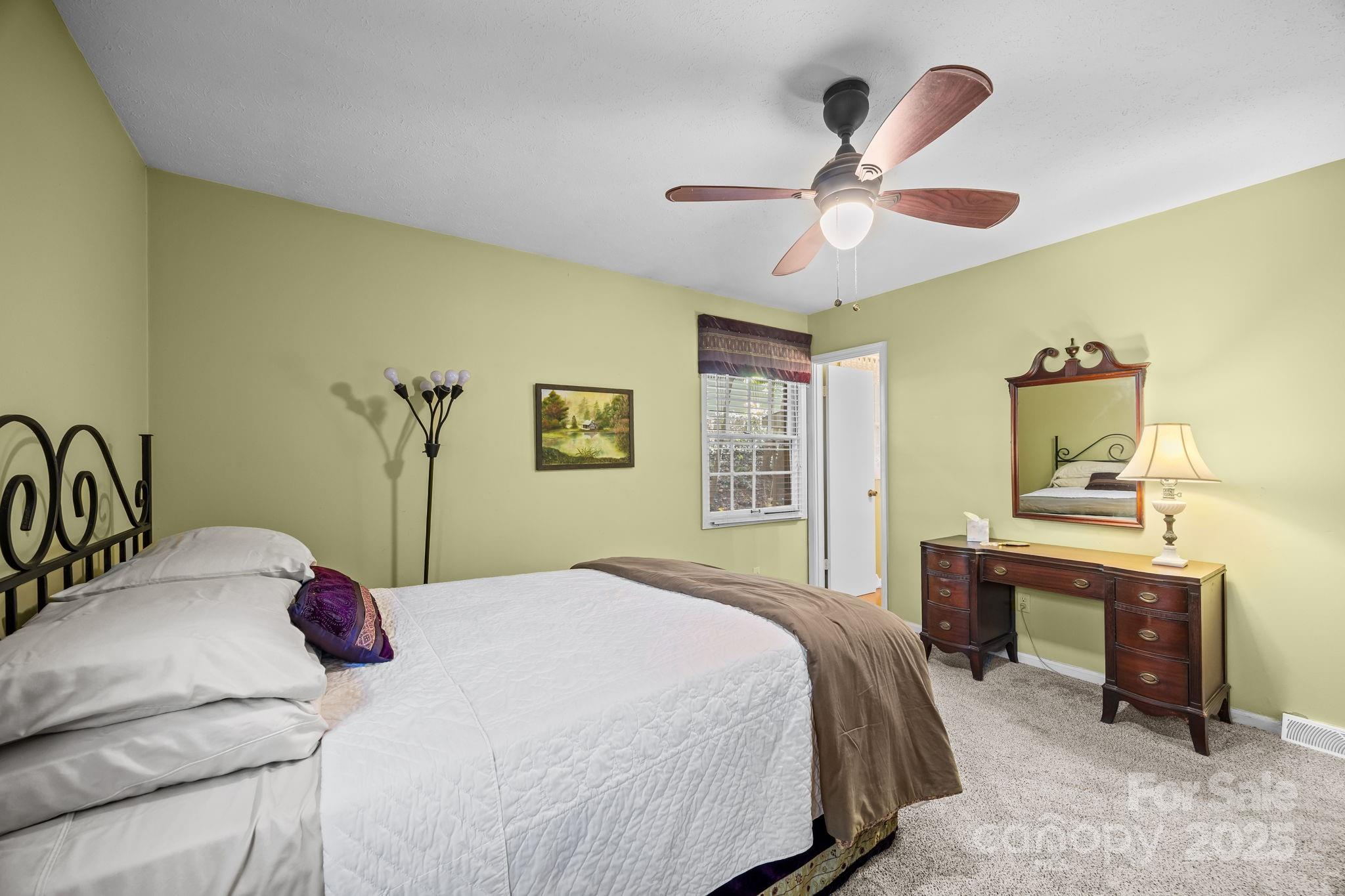 3228 Sweeten Creek Road Asheville, NC 28803 - Photo 38 of 48 a bedroom with a bed and a table