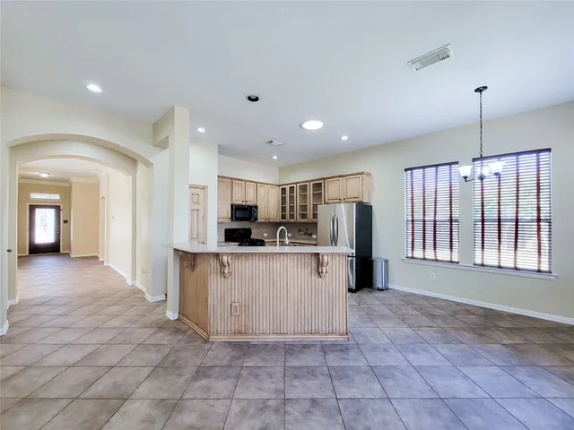 a bathroom with a granite countertop toilet a sink and a bathtub