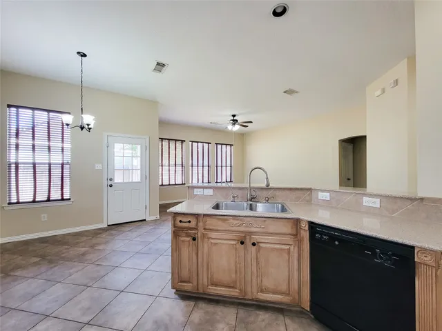 a view of backyard with wooden floor and fence