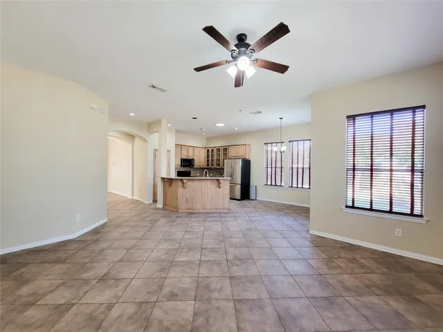 a view of a kitchen with a sink and a chandelier fan