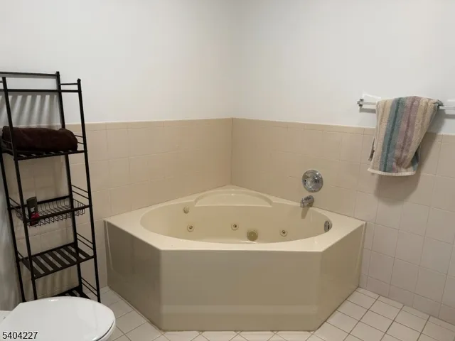 a white bath tub sitting next to a toilet