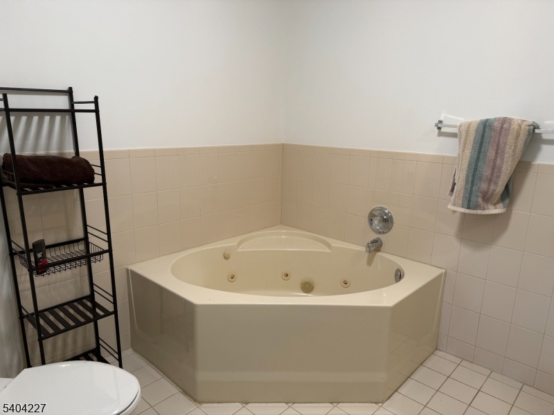 6 Paula Way Berkeley Heights, NJ 07922 - Photo 12 of 14 a white bath tub sitting next to a toilet
