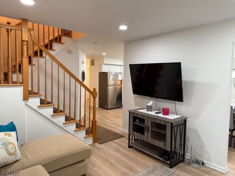 6 Paula Way Berkeley Heights, NJ 07922 - Photo 2 of 14 a living room with wooden floor and flat screen tv