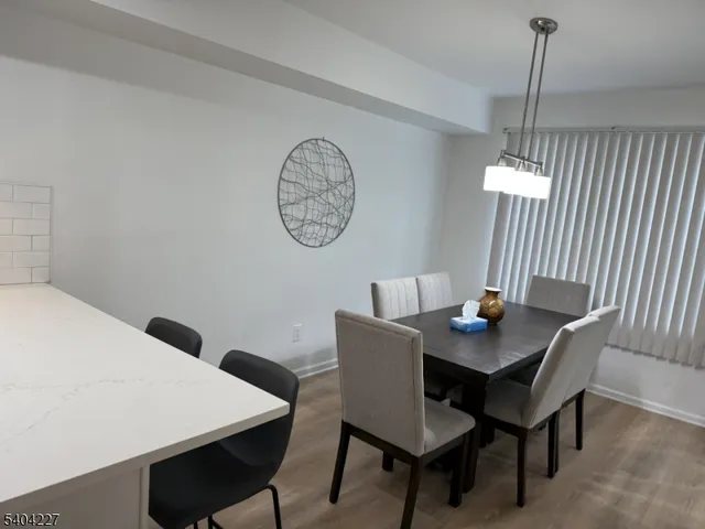 a view of a dining room with a table and chairs