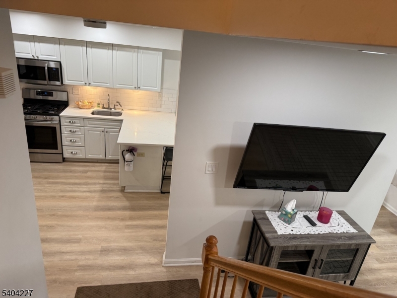 6 Paula Way Berkeley Heights, NJ 07922 - Photo 8 of 14 a kitchen with stainless steel appliances kitchen island granite countertop a stove and a microwave