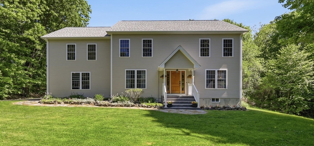 a front view of a house with a yard