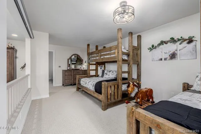 a bedroom with furniture and a chandelier