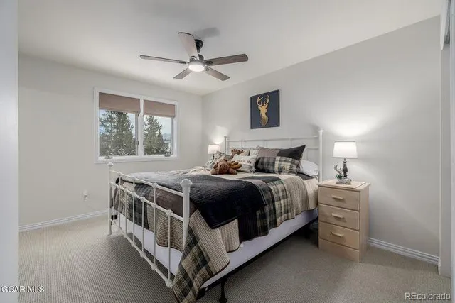 a bedroom with a bed next to a window