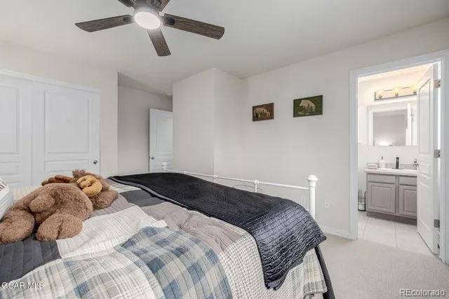 a bedroom with a bed and ceiling fan
