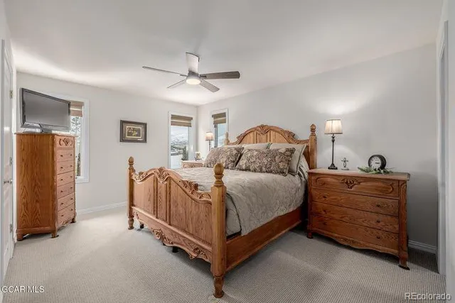 a spacious bedroom with a bed and a chandelier