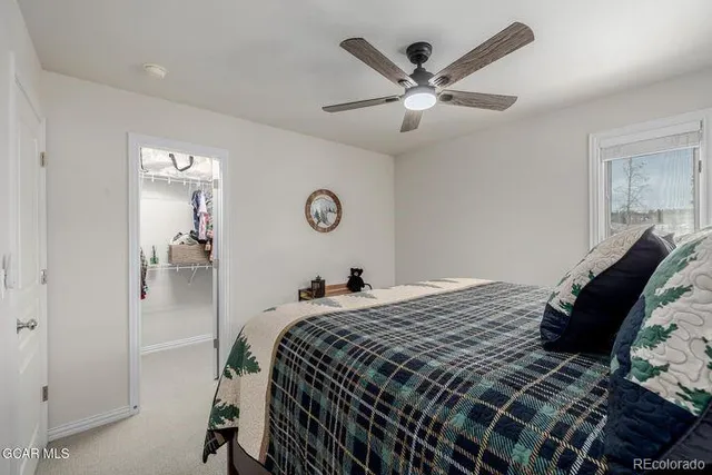 a bedroom with a large bed and a chandelier