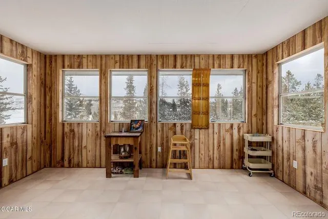 a view of a livingroom with furniture and floor to ceiling windows