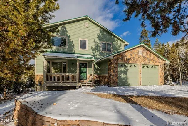 a view of a house with a yard and trees