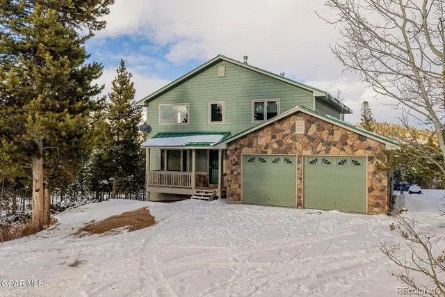a view of a house with a yard and garage