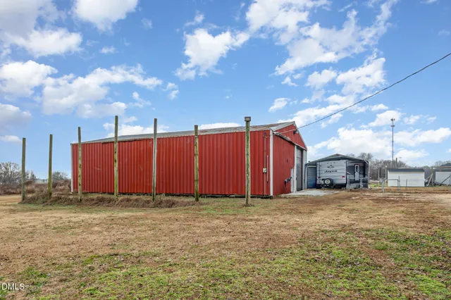 a view of a house with a big yard and a large tree