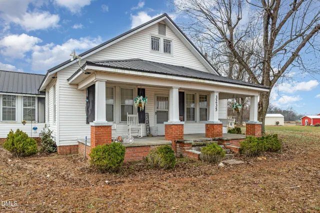 a front view of a house with garden and porch