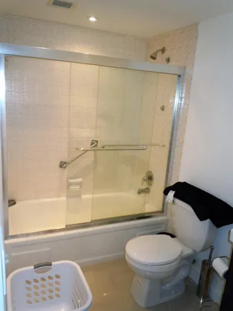 a bathroom with a toilet and a shower