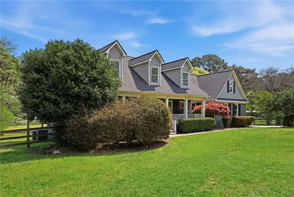 a front view of a house with a garden