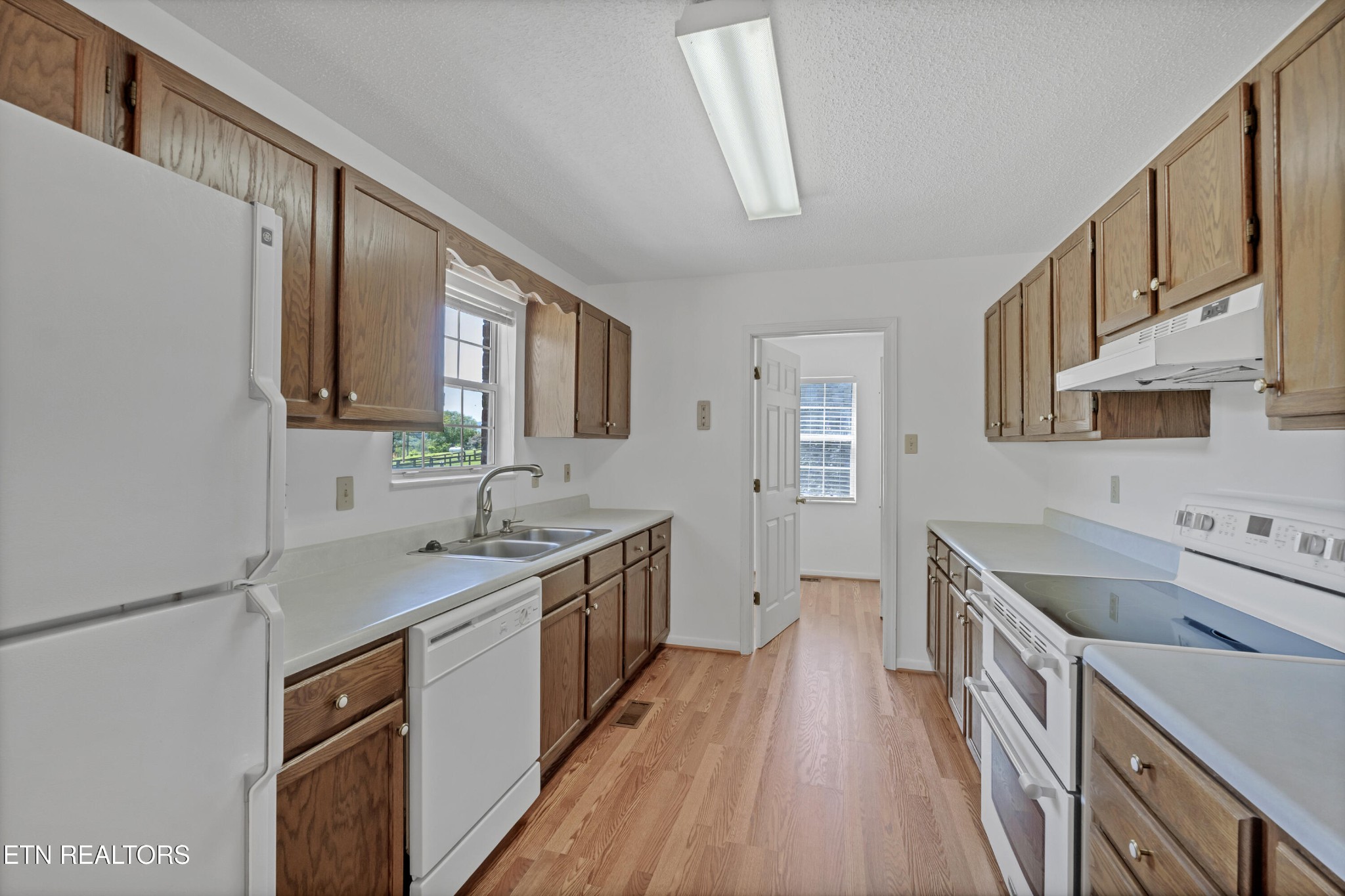 2036 Little Best Road Maryville, TN 37803 - Photo 9 of 54 a kitchen with a sink stove top oven and wooden floor