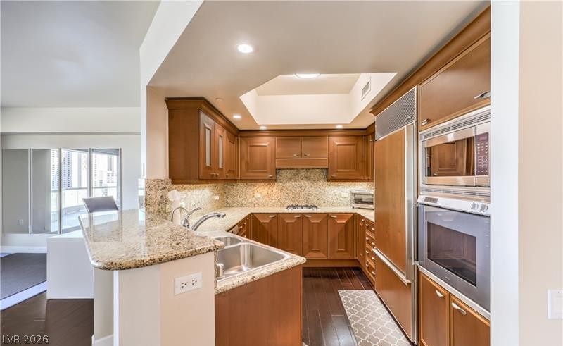 2777 Paradise Road, Unit 807 Las Vegas, NV 89109 - Photo 37 of 61 Custom cabinetry and rich granite surfaces define this well-appointed kitchen.