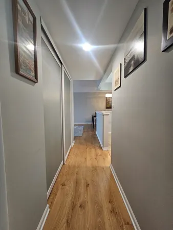 a view of a hallway with wooden floor