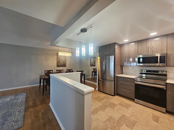 a kitchen with refrigerator cabinets and a sink